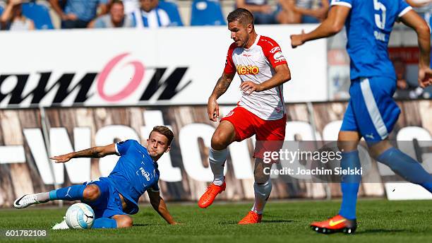 Nico Neidhart of Lotte challenges Marco Gruettner of Regensburg during the third league match between Sportfreunde Lotte and Jahn Regensburg at Frimo...