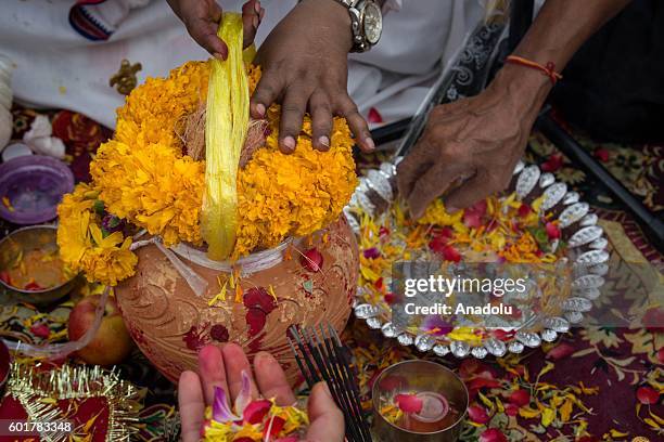 Hindu devotees prepare the 'Dahi Handi', a clay pot containing curd, honey and money during the Ganesh Chaturthi in Bangkok, Thailand on September...