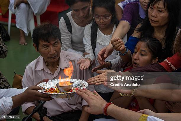 Hindu devotees prepare the 'Dahi Handi', a clay pot containing curd, honey and money during the Ganesh Chaturthi in Bangkok, Thailand on September...