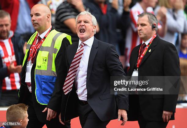 Mark Hughes, Manager of Stoke City reacts after being sent to the stands during the Premier League match between Stoke City and Tottenham Hotspur at...