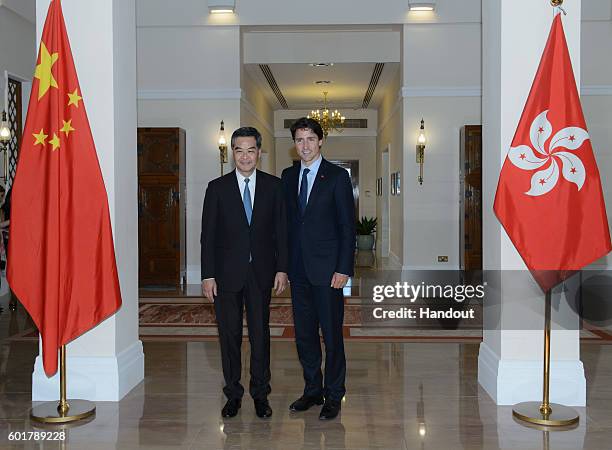 Handout picture from Hong Kong's Information Services Department shows Hong Kong's Chief Executive Leung Chun-ying with Canadian Prime Minister...
