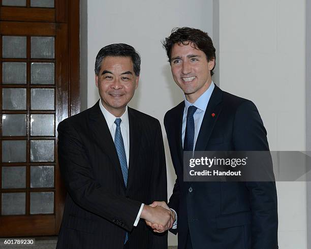 Handout picture from Hong Kong's Information Services Department shows Hong Kong's Chief Executive Leung Chun-ying shaking hands with Canadian Prime...