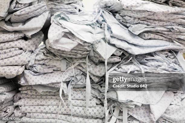 close up of folded hospital gowns - hospital gown stock pictures, royalty-free photos & images