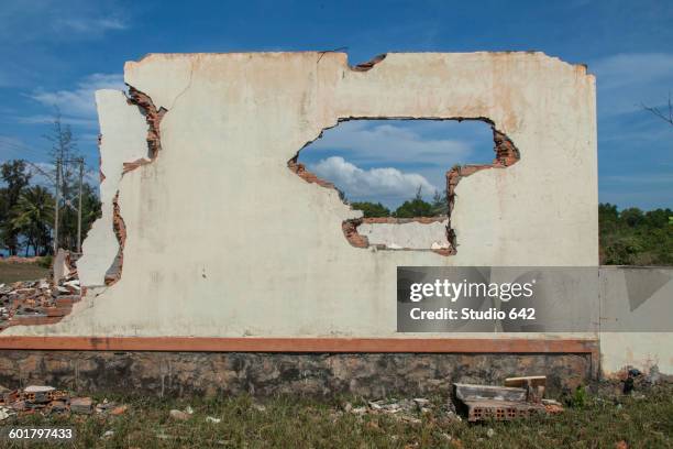 walls of demolished house in rural field - vietnam wall stock pictures, royalty-free photos & images