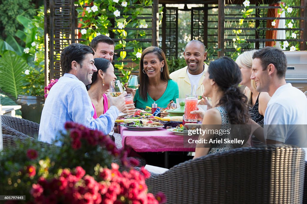 Friends talking at table outdoors