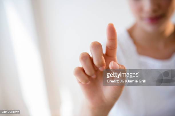 close up of hispanic woman pointing - finger studio close up stock-fotos und bilder