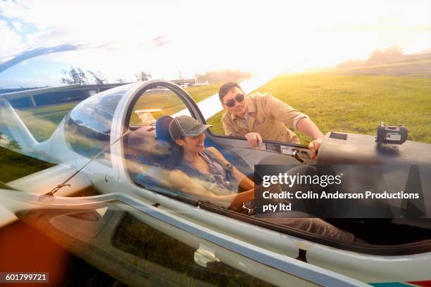 woman taking flying lessons in glider airplane - glider - fotografias e filmes do acervo