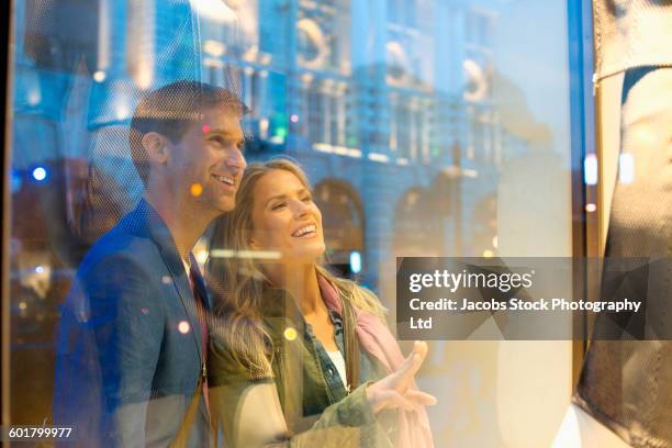 caucasian couple window shopping - shop window stock pictures, royalty-free photos & images
