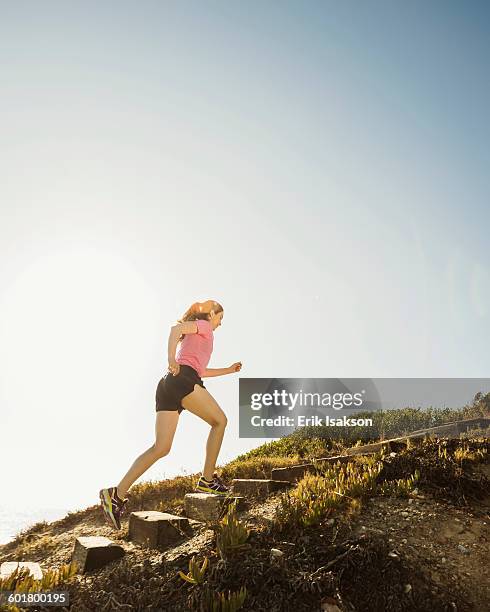 caucasian woman jogging uphill - uphill stock pictures, royalty-free photos & images