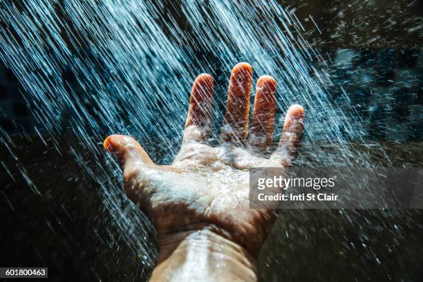 caucasian man rinsing hand under water - men taking shower stock-fotos und bilder
