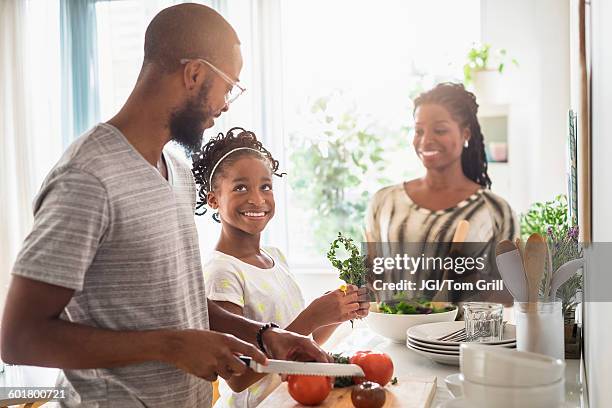 black family cooking in kitchen - black mother and child cooking stock-fotos und bilder