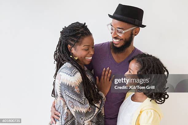 smiling black family hugging - mother on white background stock pictures, royalty-free photos & images