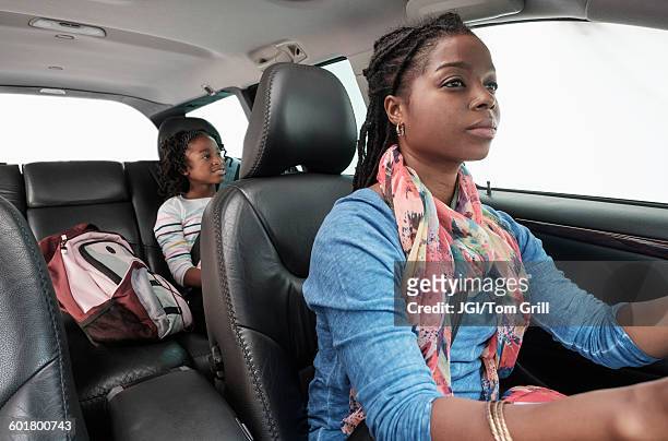 black mother and daughter driving in car - carpool stock pictures, royalty-free photos & images