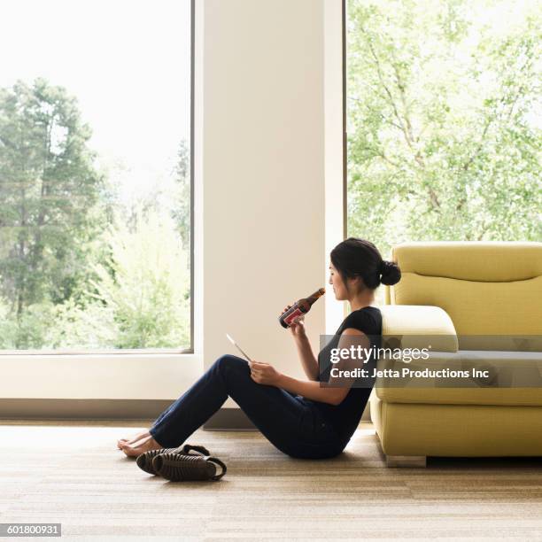 japanese businesswoman drinking beer in empty office - drinking alcohol at home stock pictures, royalty-free photos & images