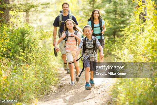 caucasian family hiking on path - lane sisters stockfoto's en -beelden