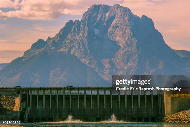 mountain and dam in remote landscape - snake river stock-fotos und bilder