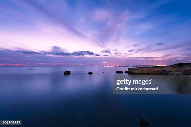 sunset over the sea, punta delle formiche, sicily - formiche imagens e fotografias de stock