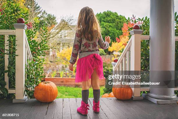 rear view of girl with skirt tucked into her underwear - kids in undies stockfoto's en -beelden