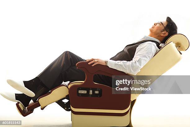 business people lean on the chair - jet lag stockfoto's en -beelden