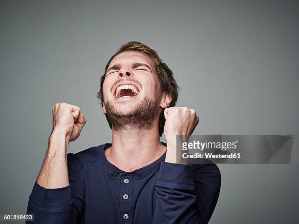 portrait of angry young man - upset man stock pictures, royalty-free photos & images