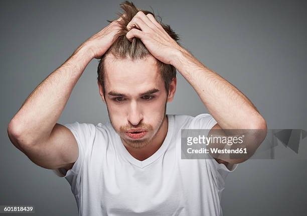 portrait of distraught young man - man looking upset fotografías e imágenes de stock