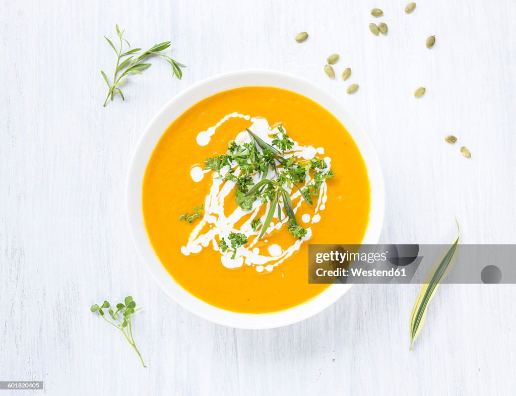 Bowl of carrot pumpkin soup with topping
