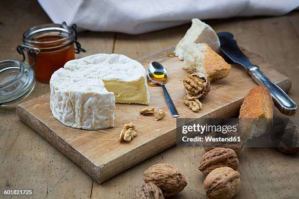 camembert, bread, walnuts and honey on wood - camambert stock pictures, royalty-free photos & images