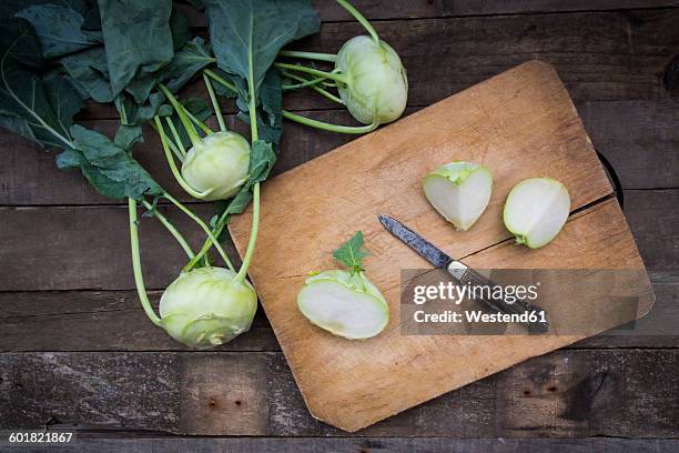 organic kohlrabi on wood, knife on chopping board, halved - cut cabbage stock pictures, royalty-free photos & images