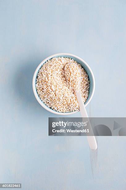 bowl of popped amarant on light blue background - amarant stock pictures, royalty-free photos & images