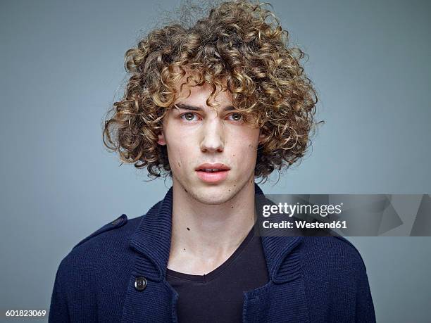 portrait of young man with curly blond hair - man fringe stock pictures, royalty-free photos & images