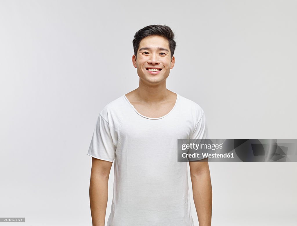 Portrait of smiling young man wearing white t-shirt