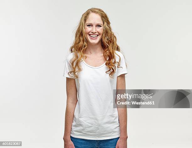 portrait of smiling young woman with long blond hair - three quarter length stockfoto's en -beelden