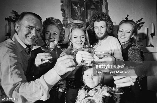 From left to right, English actor Sir John Mills , his wife Mary , and their children Juliet, Jonathan and Hayley, celebrating the New Year in...