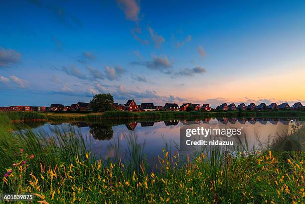 houses along the river at sunset, arnhem, gelderland, netherlands - arnheim stock-fotos und bilder