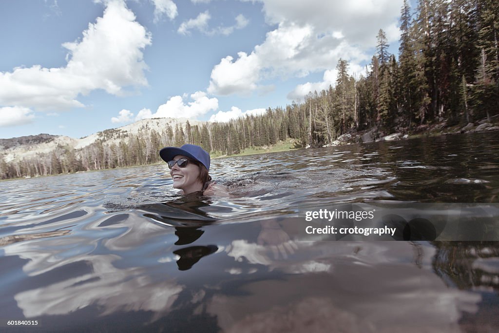 Woman swimming in mountain lake, Wyoming, America, USA