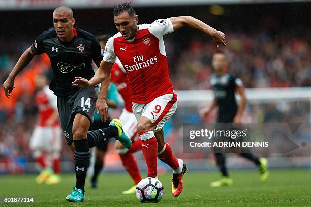 Arsenal's Spanish striker Lucas Perez vies with Southampton's Sepanish midfielder Oriol Romeu during the English Premier League football match...