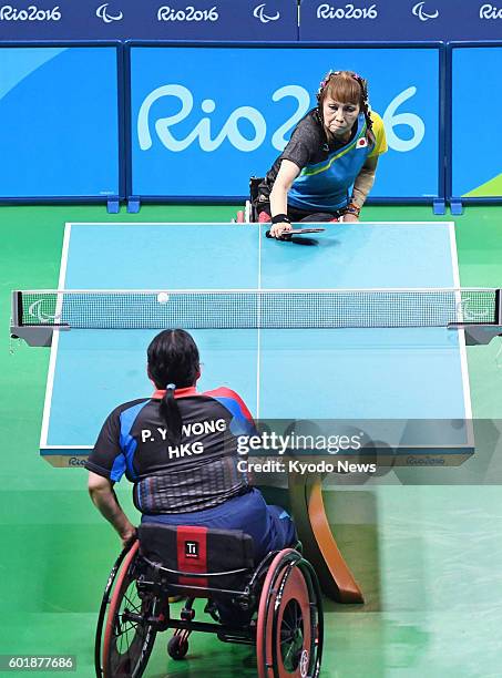 Kimie Bessho , a 68-year-old Japanese table tennis player in a wheelchair, competes against Pui Yi Wong of Hong Kong in the women's singles...