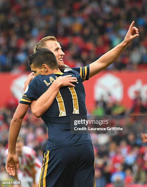 Harry Kane of Tottenham Hotspur celebrates scoring his sides first goal with Erik Lamela of Tottenham Hotspur during the Premier League match between...