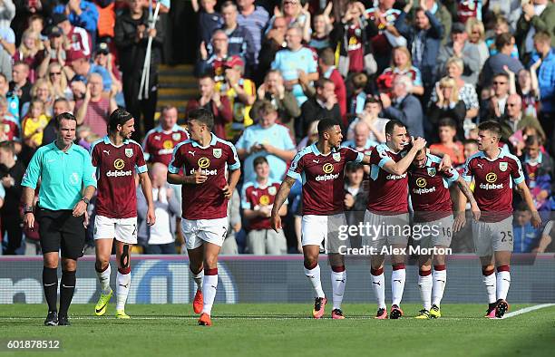 Steven Defour of Burnley celebrates scoring his sides first goal with his team mates during the Premier League match between Burnley and Hull City at...