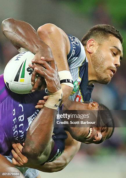 Suliasi Vunivalu of the Storm is tackled by Antonio Winterstein of the Cowboys during the NRL Qualifying Final match between the Melbourne Storm and...