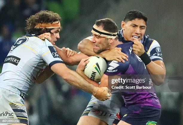 Cameron Smith of the Storm is tackled during the NRL Qualifying Final match between the Melbourne Storm and the North Queensland Cowboys at AAMI Park...