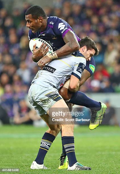 Suliasi Vunivalu of the Storm is tackled by Lachlan Coote of the Cowboys during the NRL Qualifying Final match between the Melbourne Storm and the...