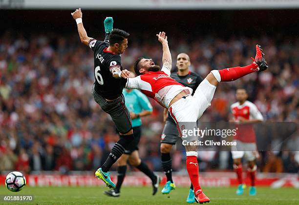 Jose Fonte of Southampton fouls Olivier Giroud of Arsenal in the box during the Premier League match between Arsenal and Southampton at Emirates...