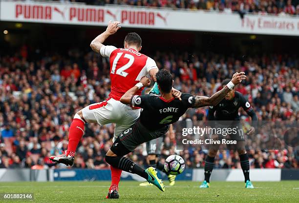 Jose Fonte of Southampton pulls Olivier Giroud of Arsenal down in the penalty area during the Premier League match between Arsenal and Southampton at...