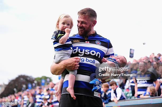 Dave Attwood of Bath Rugby celebrates victory with his children during the Aviva Premiership match between Bath Rugby and Newcastle Falcons at the...