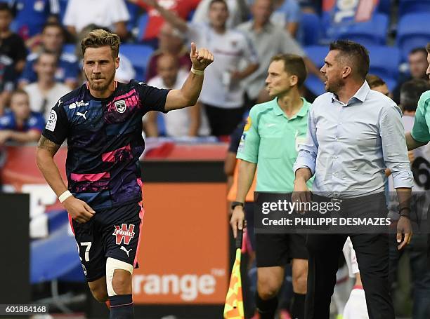 Bordeaux's French defender Gregory Sertic reacts after scoring his team's second goal as Bordeaux's French head coach Jocelyn Gourvennec looks on...