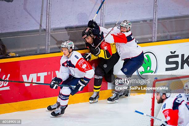 Jamie Macqueen of Eisbaren Berlin hits Matti Jarvinen of SaiPa Lappeenranta during the Champions Hockey League match between SaiPa Lappeenranta and...