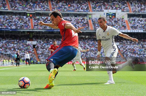 Unai Garcia of CA Osasuna clears the ball from Pepe of Real Madrid during the La Liga match between Real Madrid CF and CA Osasuna at Estadio Santiago...