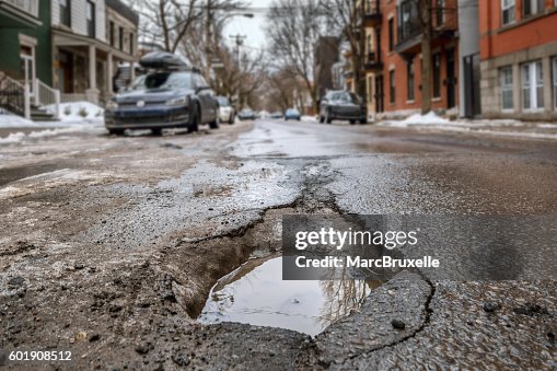 Large deep pothole in Montreal street, Canada. Large deep pothole in Montreal street, Canada.