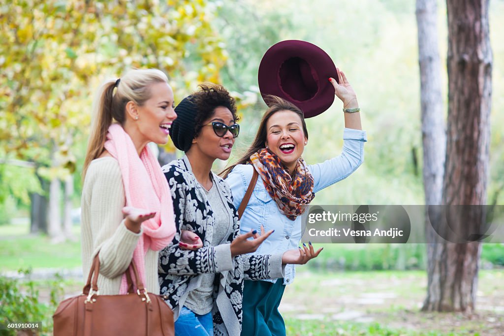 Happy woman walking through park